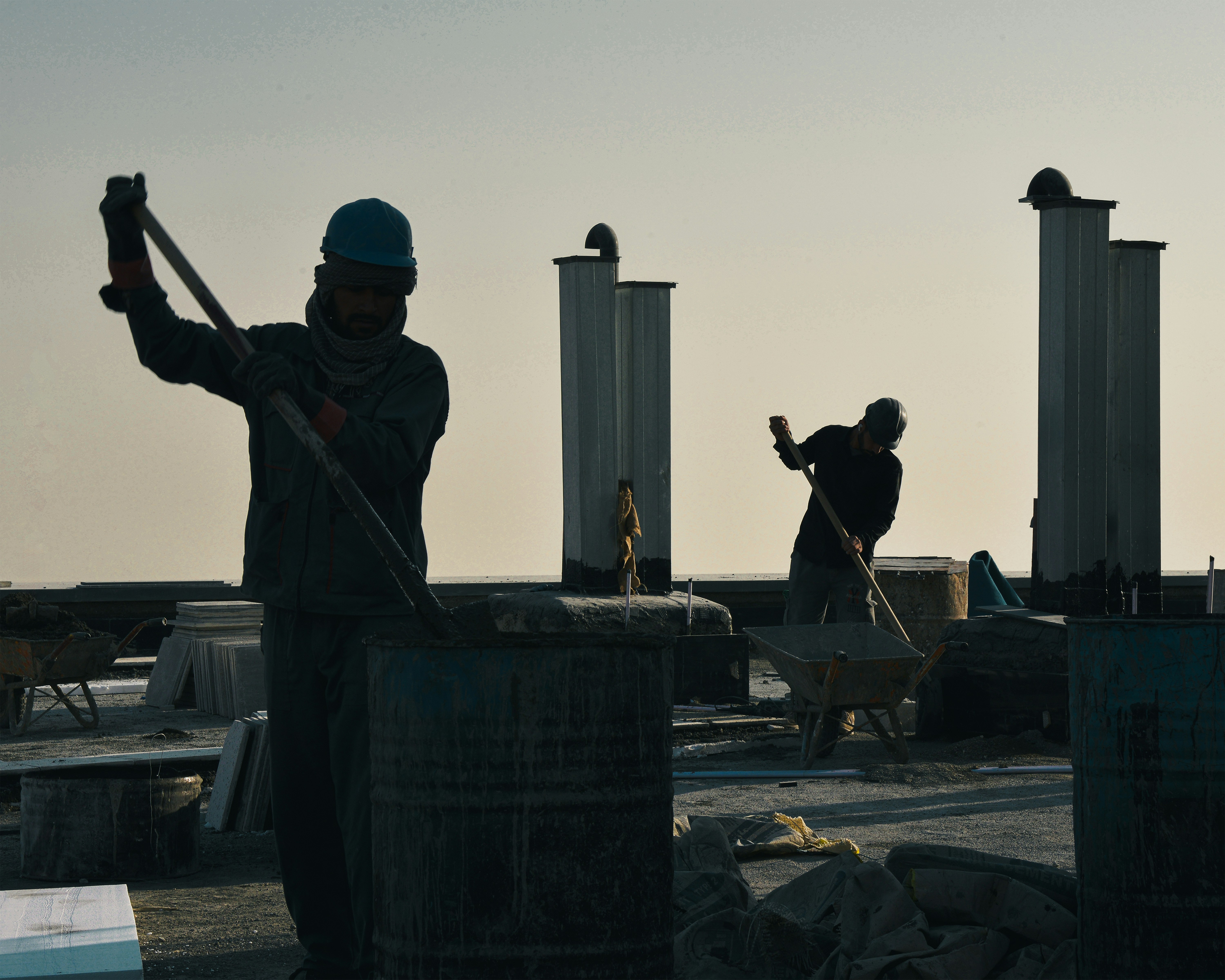 Construction site workers at dawn